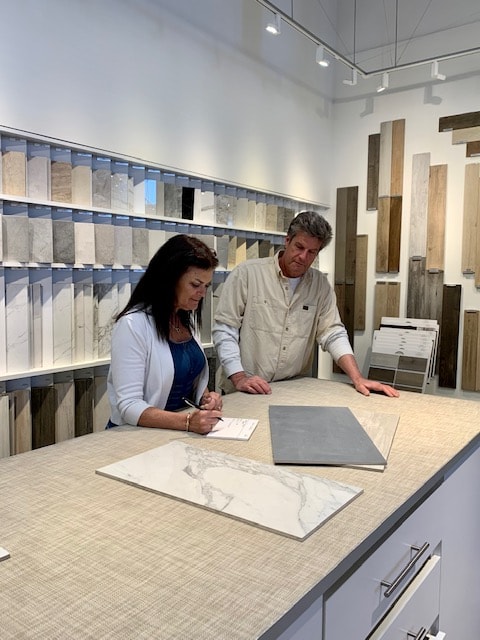 Dino Presutto and a homeowner reviewing material selections at a design showroom — Tuscany Builders South Orange County