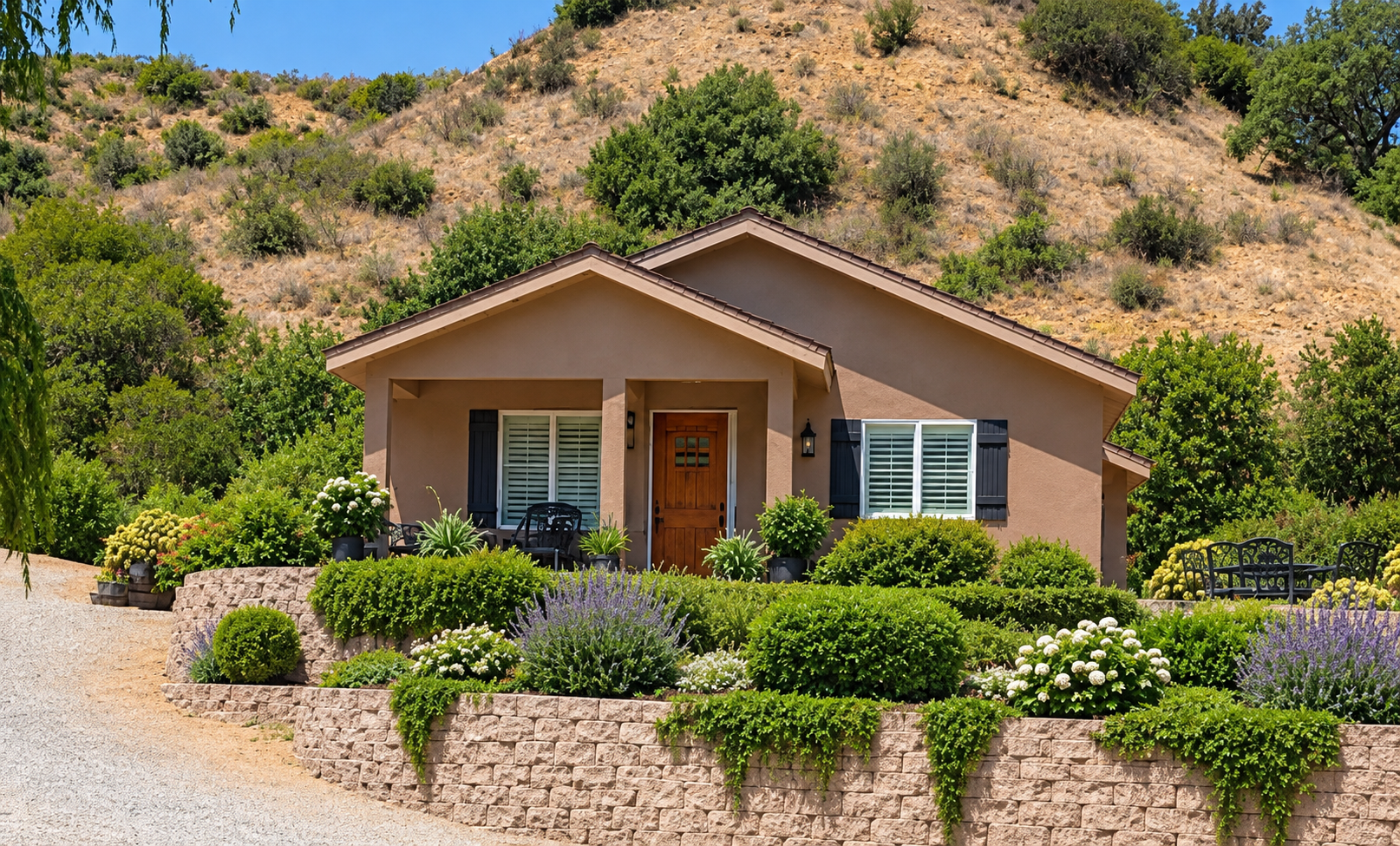 Custom hillside home rebuilt by Tuscany Builders in South Orange County, featuring terraced retaining walls and fire-resilient landscaping.